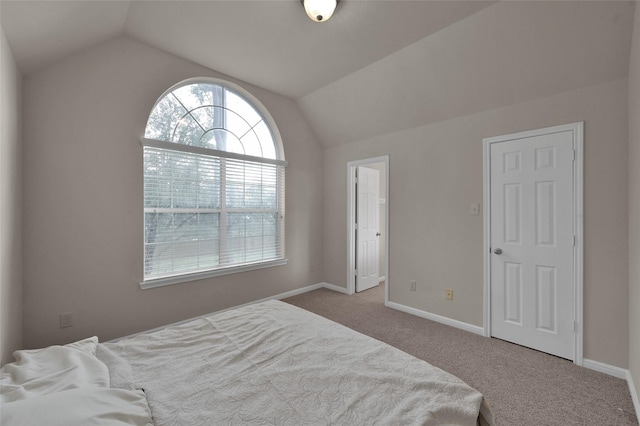 bedroom with carpet, vaulted ceiling, and baseboards