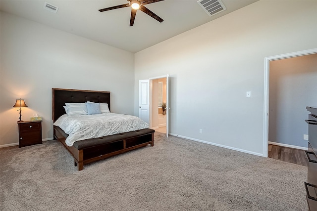 carpeted bedroom featuring high vaulted ceiling, visible vents, ceiling fan, and baseboards