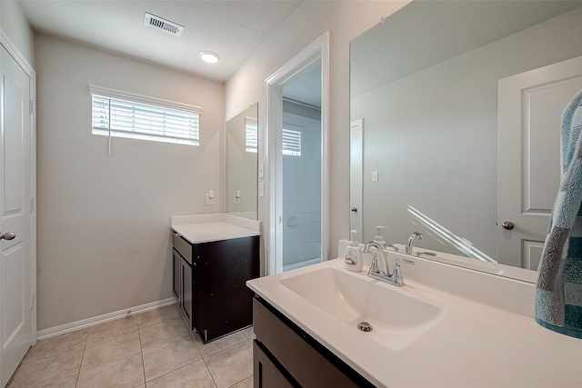 bathroom featuring baseboards, vanity, visible vents, and tile patterned floors