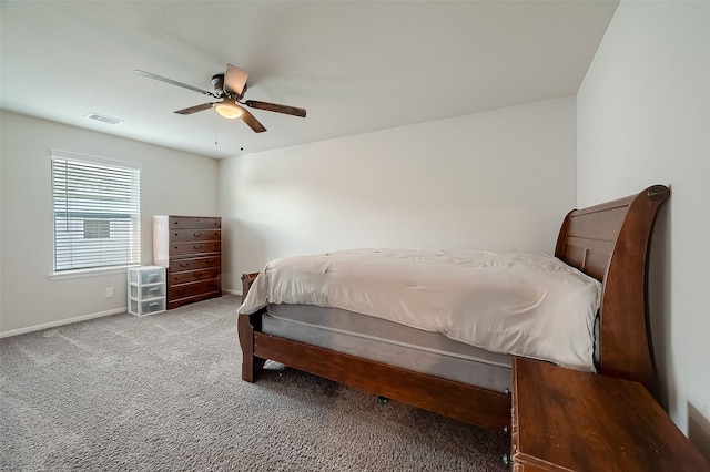 carpeted bedroom with ceiling fan, visible vents, and baseboards