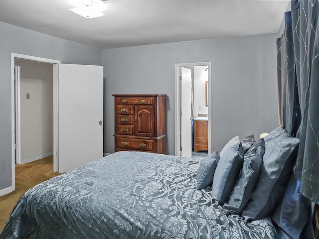 carpeted bedroom featuring ensuite bathroom