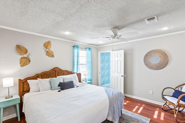 bedroom featuring baseboards, ornamental molding, and wood finished floors