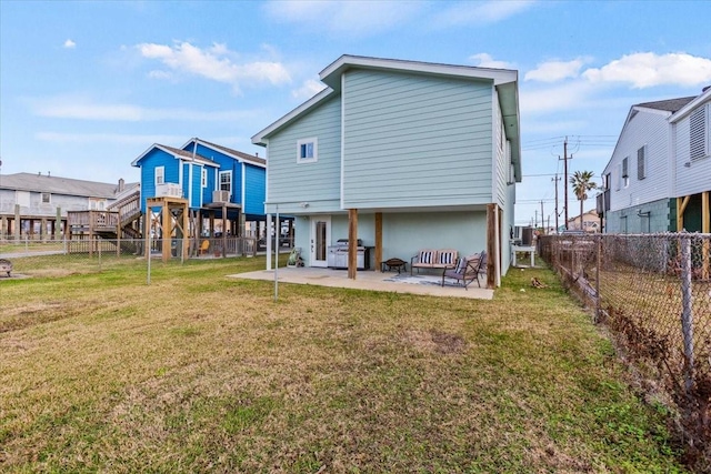 back of house featuring a patio area, a lawn, and a fenced backyard