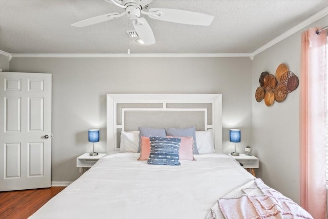 bedroom featuring a ceiling fan, crown molding, a textured ceiling, and wood finished floors