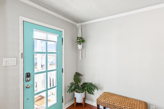 doorway to outside featuring a textured ceiling, baseboards, crown molding, and wood finished floors