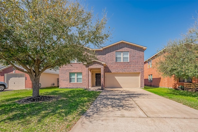 traditional home with brick siding, driveway, an attached garage, and a front lawn