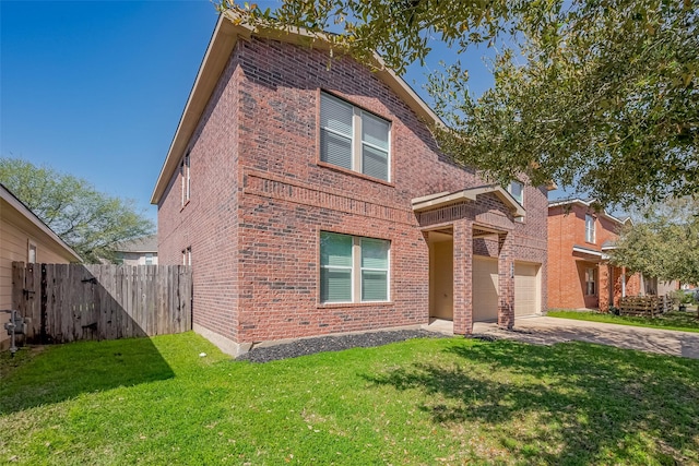 view of front of house featuring a front lawn, concrete driveway, fence, and brick siding