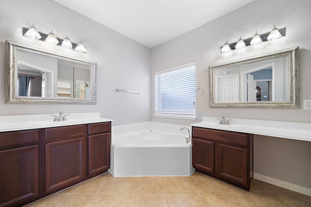 bathroom with a garden tub, two vanities, and a sink