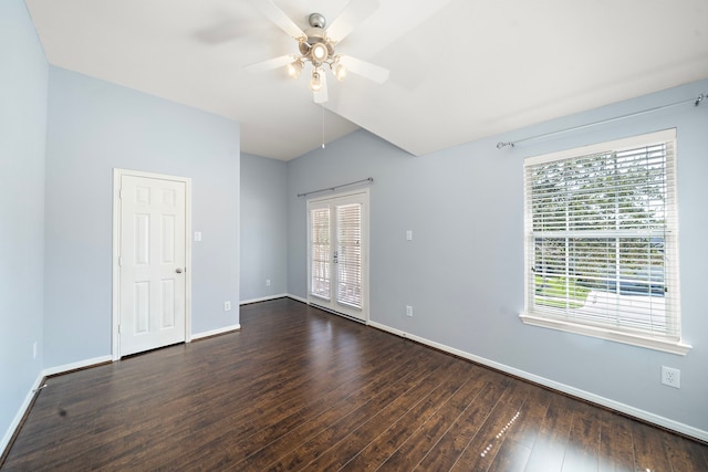 unfurnished room featuring baseboards, dark wood finished floors, and a ceiling fan