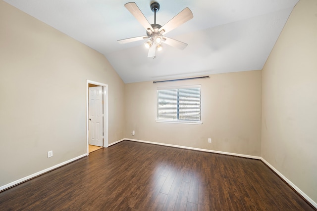 spare room featuring vaulted ceiling, wood finished floors, a ceiling fan, and baseboards