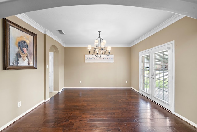 spare room with baseboards, visible vents, arched walkways, and hardwood / wood-style floors