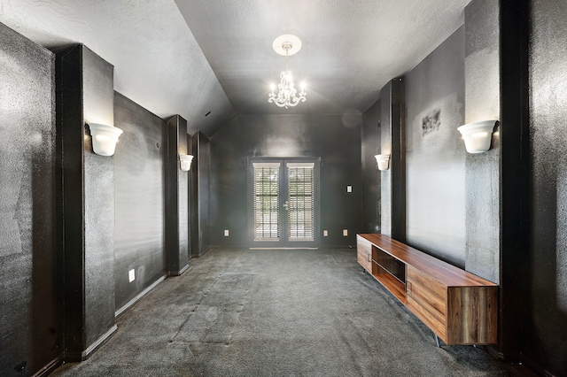 unfurnished living room with vaulted ceiling, french doors, carpet flooring, and a notable chandelier