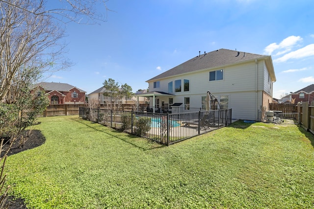 rear view of house with a patio area, a fenced backyard, a fenced in pool, and a yard