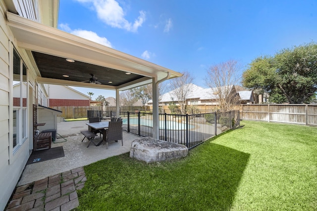 view of yard with ceiling fan, a patio, a fenced backyard, and a fenced in pool