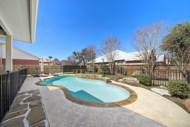 view of swimming pool featuring a patio area, a fenced backyard, and a fenced in pool