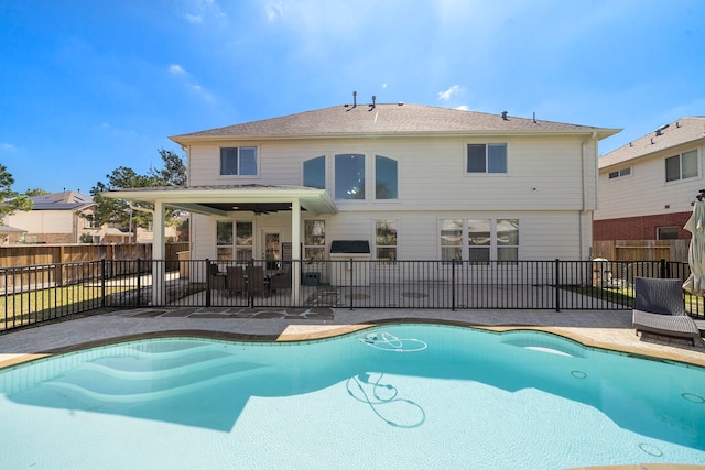 view of pool featuring a patio area, fence, and a fenced in pool