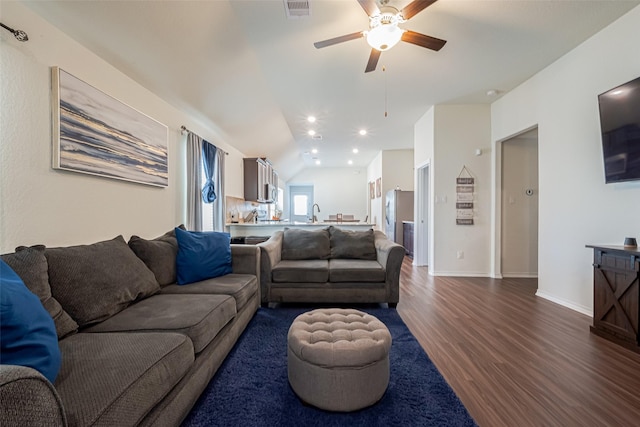 living area with baseboards, visible vents, a ceiling fan, lofted ceiling, and dark wood-style flooring