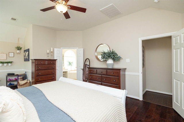 bedroom featuring lofted ceiling, visible vents, dark wood finished floors, and baseboards