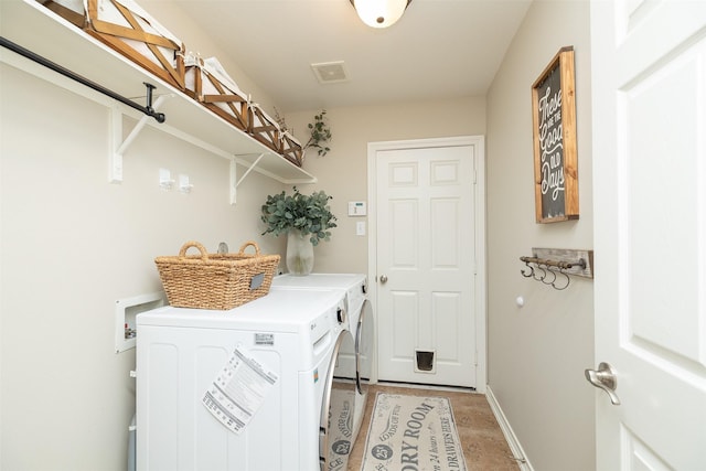 laundry area featuring laundry area, separate washer and dryer, visible vents, and baseboards