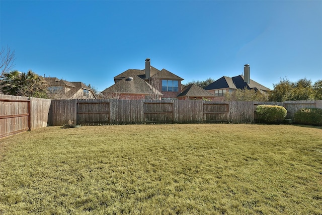 view of yard with a fenced backyard