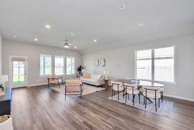 living area with recessed lighting, baseboards, and wood finished floors