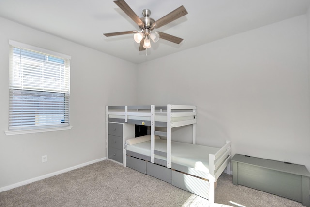 unfurnished bedroom with carpet, baseboards, and ceiling fan