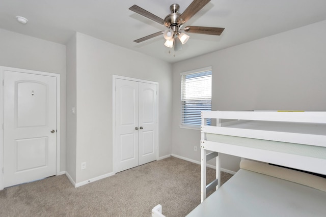 unfurnished bedroom with carpet, a closet, and baseboards