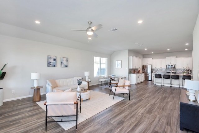 living area with baseboards, visible vents, dark wood-style flooring, and recessed lighting