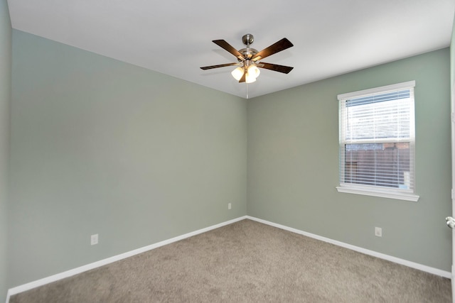 unfurnished room with carpet, baseboards, and ceiling fan