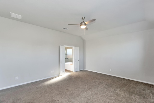 carpeted spare room featuring lofted ceiling, baseboards, visible vents, and a ceiling fan