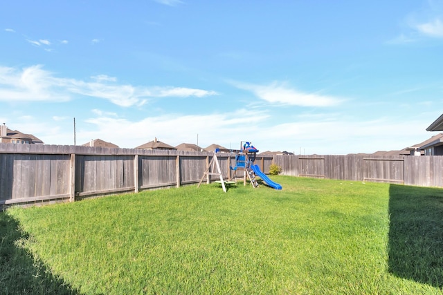 view of yard featuring a playground and a fenced backyard