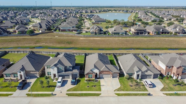 birds eye view of property featuring a residential view and a water view