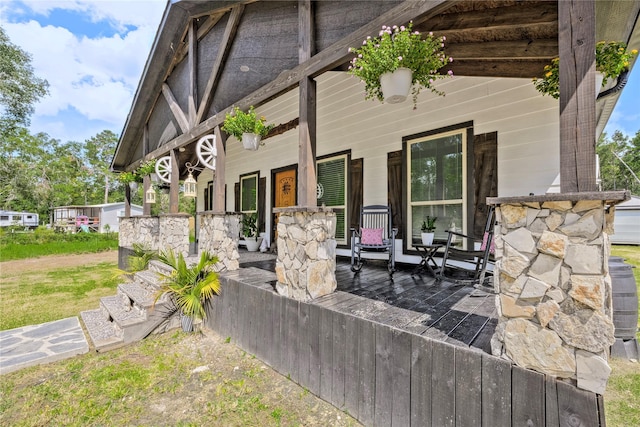 doorway to property with a porch and central air condition unit