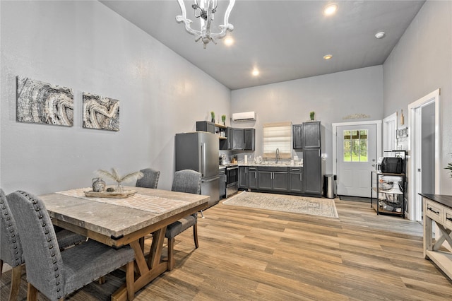 dining room with light wood-style floors, a chandelier, and recessed lighting