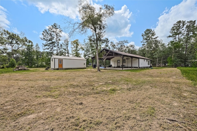 view of yard with an outbuilding and a storage shed