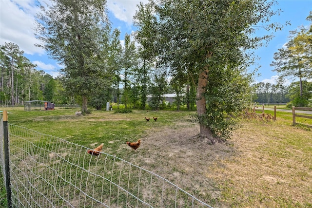 view of yard featuring a rural view and fence