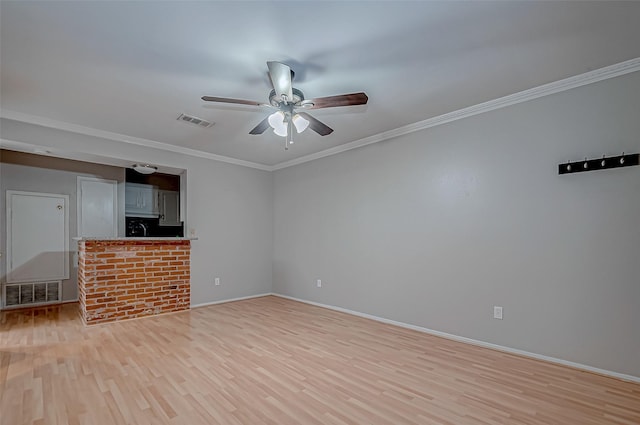 unfurnished living room featuring ornamental molding, light wood-type flooring, visible vents, and a ceiling fan