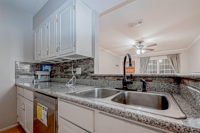 kitchen featuring dishwasher, light countertops, a sink, and visible vents