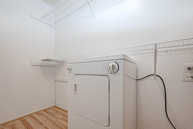 laundry area with laundry area, washer / clothes dryer, and light wood-type flooring