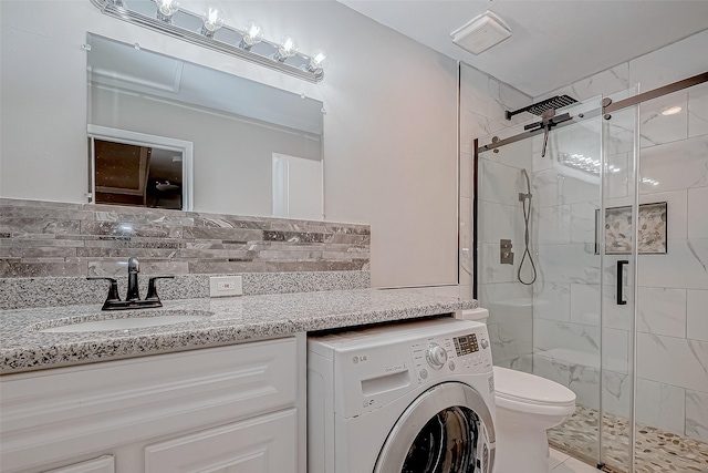 bathroom featuring washer / dryer, visible vents, and a shower stall