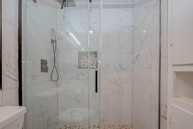 full bathroom with a stall shower and toilet