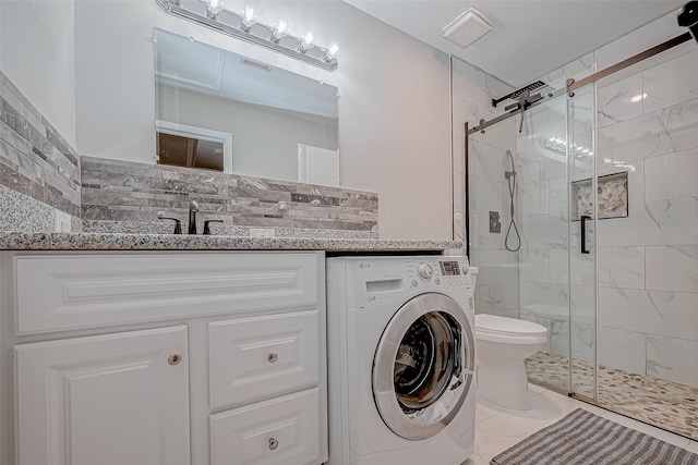 full bathroom featuring toilet, visible vents, marble finish floor, a shower stall, and washer / dryer