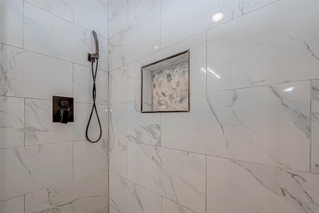 full bathroom with a tile shower