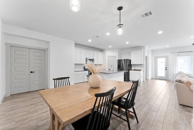 13220 Lago Acero Ln, Texas City, TX 77568 - dining space featuring light wood finished floors and recessed lighting