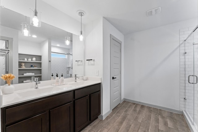 13220 Lago Acero Ln, Texas City, TX 77568 - full bath with a closet, a shower stall, wood finished floors, and double vanity