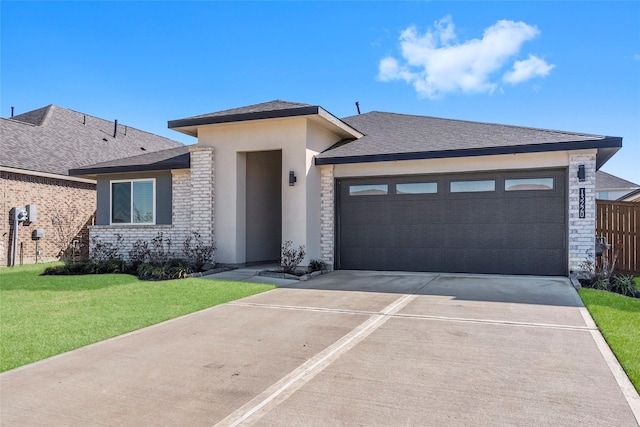 13220 Lago Acero Ln, Texas City, TX 77568 - prairie-style house featuring driveway, a garage, a front yard, stone siding, and stucco siding