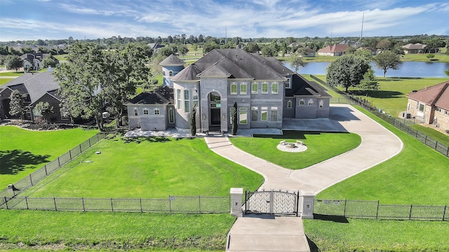 exterior space with a fenced front yard, a front yard, a gate, and a water view