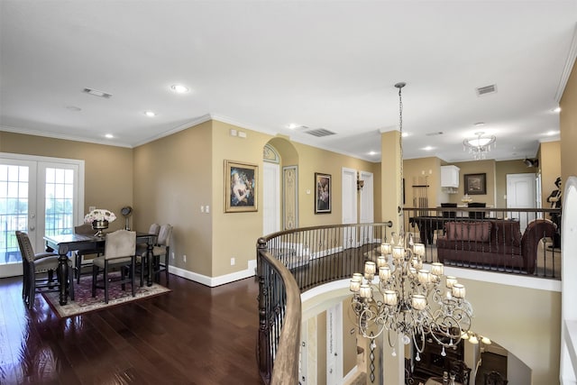 dining room featuring french doors, crown molding, visible vents, wood finished floors, and baseboards