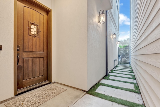 view of exterior entry with stucco siding