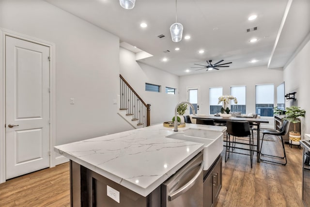 kitchen with recessed lighting, a sink, visible vents, dishwasher, and light wood finished floors